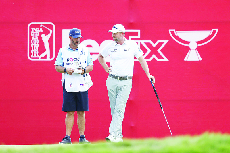 DETROIT:  Webb Simpson of the United States talks with his caddie Paul Tesori during the second round of the Rocket Mortgage Classic at the Detroit Golf Club in Detroit, Michigan. — AFP