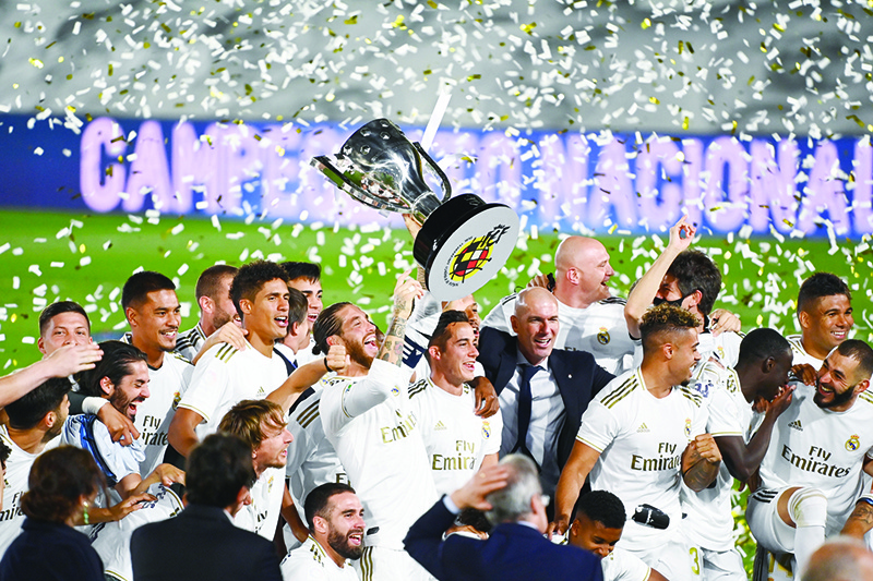 VALDEBEBAS: Real Madrid’s players celebrate winning the Liga title after the Spanish League football match between Real Madrid CF and Villarreal CF at the Alfredo di Stefano stadium in Valdebebas, on the outskirts of Madrid, on July 16, 2020.  — AFP