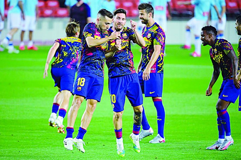BARCELONA: File photo shows  Barcelona’s Spanish defender Jordi Alba (L) and Barcelona’s Argentine forward Lionel Messi warm up with teammates before the Spanish League football match between Barcelona and Espanyol at the Camp Nou stadium in Barcelona on July 8, 2020. —AFP