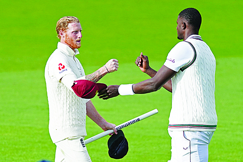 MANCHESTER: England’s Ben Stokes (L) fist bumps with West Indies’ Jason Holder on the pitch after England wrap up the Test on the final day of the second Test cricket match between England and the West Indies at Old Trafford. —AFP