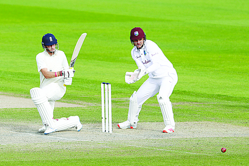 England's Joe Root plays a shot on the third day of the third Test cricket match between England and the West Indies at Old Trafford in Manchester, northwest England on July 26, 2020. (Photo by Michael Steele / POOL / AFP) / RESTRICTED TO EDITORIAL USE. NO ASSOCIATION WITH DIRECT COMPETITOR OF SPONSOR, PARTNER, OR SUPPLIER OF THE ECB
