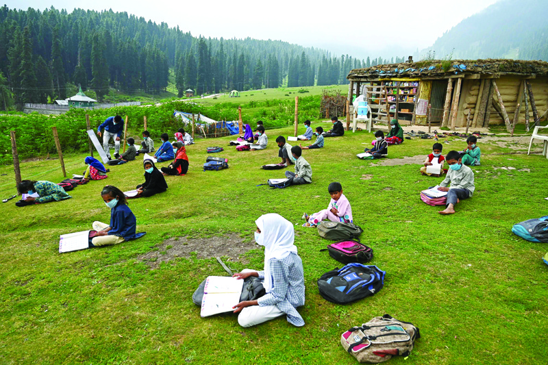 Students attend a class at their open-air school situated on top of a mountain in Doodhpathri, Indian-administered Kashmir, on July 27, 2020. - Schooling in restive Kashmir has been severely disrupted by the pandemic, but also after a strict curfew was imposed almost a year ago when New Delhi stripped the Muslim-majority region of 14 million people of its semi-autonomy. (Photo by Tauseef MUSTAFA / AFP)