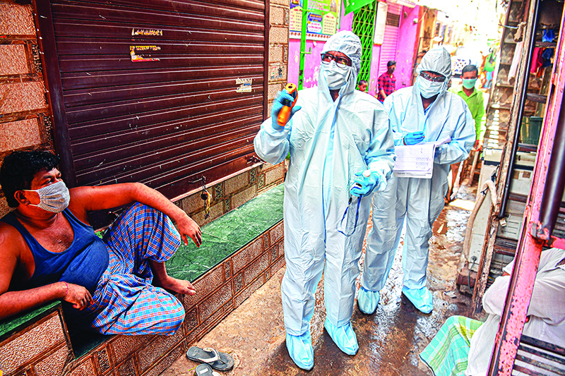MUMBAI: Medical staff wearing Personal Protective Equipment (PPE) gear conduct a door-to-door medical screening inside Dharavi slums to fight against the spread of the COVID-19 coronavirus. — AFP