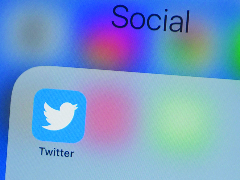 (FILES) In this file photo taken on July 10, 2019, the Twitter logo is seen on a phone in this photo illustration in Washington, DC. - The official Twitter accounts of Apple, Elon Musk, Jeff Bezos and others were hijacked on Wednesday by scammers trying to dupe people into sending cryptocurrency bitcoin in the hope of doubling their money. (Photo by Alastair Pike / AFP)