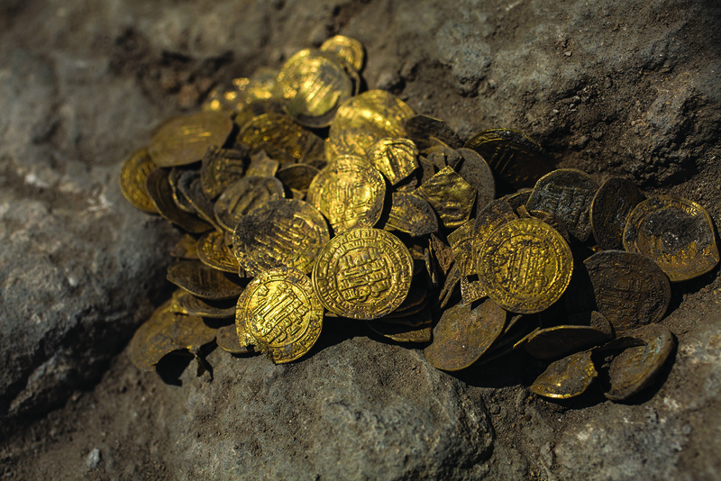 A hoard of gold coins dating to the Abbasid Caliphate is pictured during a press presentation of the discovery at an archeological site near Tel Aviv in central Israel, on August 18, 2020. - Israel's Antiquities Authority unveiled a trove of 425 gold coins said to be some 1200 years old, discovered in what was an industrial area during the Byzantine Period. (Photo by Heidi Levine / POOL / AFP)