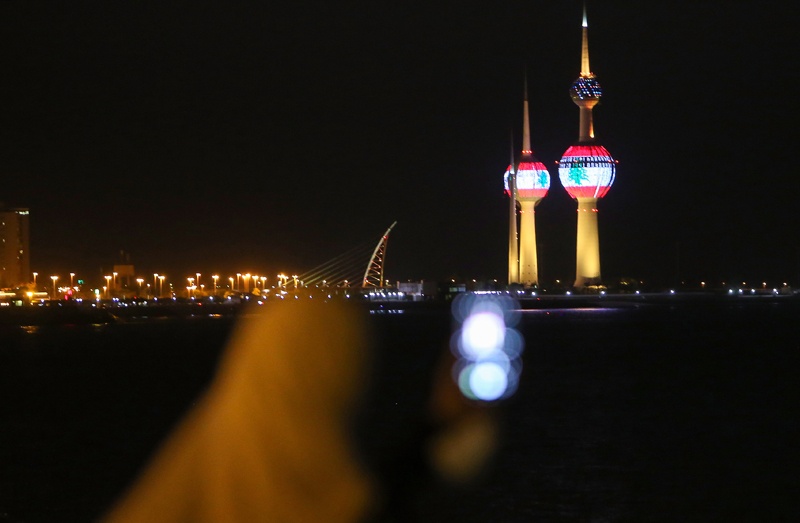 A picture taken on August 5, 2020, shows the Lebanese flag projected on the Kuwait towers in a show of solidarity one day after a mega-blast tore through the harbour in the heart of the Lebanese capital with the force of an earthquake, killing more than 100 people and injuring over 4,000. - Rescuers searched for survivors in Beirut in the morning after a cataclysmic explosion at the port sowed devastation across entire neighbourhoods, killing more than 100 people, wounding thousands and plunging Lebanon deeper into crisis. (Photo by YASSER AL-ZAYYAT / AFP)