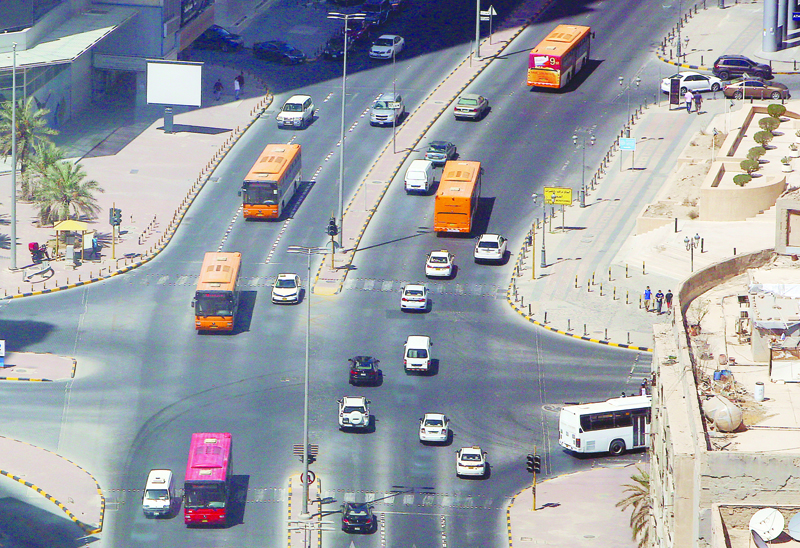 Kuwaiti public transportation buses return to the streets of Kuwait City on August 18, 2020, as businesses such as barbershops, beauty salons, gyms and spas, reopen after a 5-month shutdown due to the spread of the novel coronavirus (COVID-19). (Photo by YASSER AL-ZAYYAT / AFP)