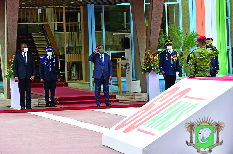 ABIDJAN: Ivory Coast President Alassane Ouattara (center), flanked by Ivorian Prime Minister Hamed Bakayoko, salutes during a ceremony to mark the 60th anniversary of the country’s Independance from France on August 7, 2020. — AFP