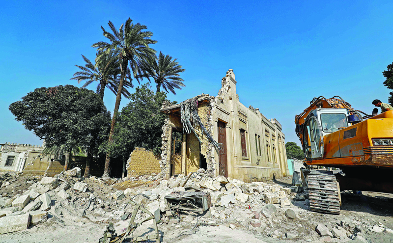 This picture taken on July 22, 2020 shows a view of a cemetery undergoing demolition amidst ongoing roadworks at the historic City of the Dead necropolis of Egypt's capital Cairo. - Egyptian mother-of-three Menna was caught off guard when a bulldozer clearing space for a controversial highway flattened much of a mausoleum that doubled as her home in a Cairo 7th century Islamic necropolis. Her parents and grandparents had made their home among the graves of the City of the Dead, where burial chambers provide shelter for thousands like her who are unable to afford prohibitively high rents in the capital. (Photo by Khaled DESOUKI / AFP)