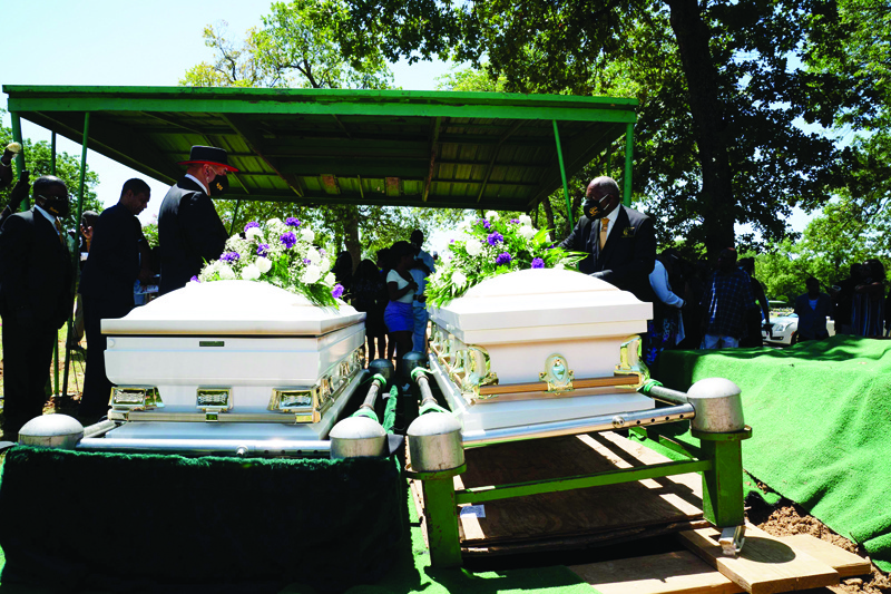 The caskets holding the bodies of Lola M. Simmons-Jones and her daughter, Lashaye Antoinette Allen, who both died of coronavirus, are placed next one another before burial at Lincoln Memorial Cemeteryin Dallas, Texas on July 30, 2020. - Lola M. Simmons-Jones passed due to the coronavirus on July 15, her daughter Lashaye Antoinette Allen passed away from the coronavirus on July 20. Dallas County reported a record number of COVID-19 related deaths in a single day at 36, according to local health officials. This brings the total to 658 confirmed deaths since the first one was reported March 19. (Photo by Bryan R. Smith / AFP)