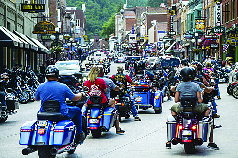 DEADWOOD, SD - AUGUST 08: Motorcyclists ride through downtown Deadwood, South Dakota during the 80th Annual Sturgis Motorcycle Rally on August 8, 2020. While the rally usually attracts around 500,000 people, officials estimate that more than 250,000 people may still show up to this year's festival despite the coronavirus pandemic.   Michael Ciaglo/Getty Images/AFPn== FOR NEWSPAPERS, INTERNET, TELCOS &amp; TELEVISION USE ONLY ==