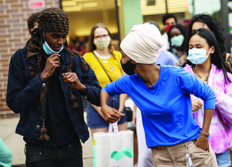 MINNEAPOLIS, MN - AUGUST 11: Rep. Ilhan Omar (D-MN) elbow bumps with supporters at a campaign stop in the Dinkytown neighborhood on August 11, 2020 in Minneapolis, Minnesota. Omar retained her seat as the representative for Minnesota's fifth congressional district after defeating her main challenger, attorney Antone Melton-Meaux, in today's primary election.   Stephen Maturen/Getty Images/AFPn== FOR NEWSPAPERS, INTERNET, TELCOS &amp; TELEVISION USE ONLY ==