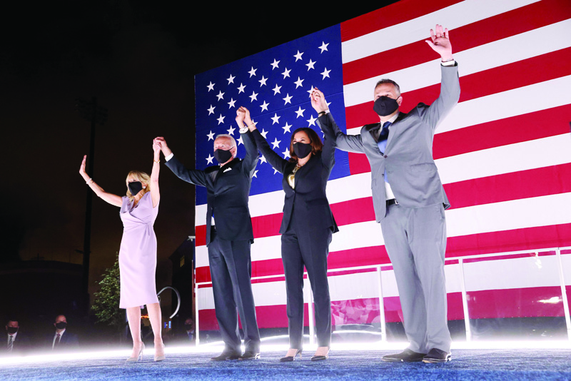 WILMINGTON, DELAWARE - AUGUST 20: Democratic presidential nominee Joe Biden, his wife Dr. Jill Biden, Democratic Vice Presidential nominee Kamala Harris and her husband Douglas Emhoff raise their arms on stage outside the Chase Center after Biden delivered his acceptance speech on the fourth night of the Democratic National Convention from the Chase Center on August 20, 2020 in Wilmington, Delaware. The convention, which was once expected to draw 50,000 people to Milwaukee, Wisconsin, is now taking place virtually due to the coronavirus pandemic.   Win McNamee/Getty Images/AFPn== FOR NEWSPAPERS, INTERNET, TELCOS &amp; TELEVISION USE ONLY ==