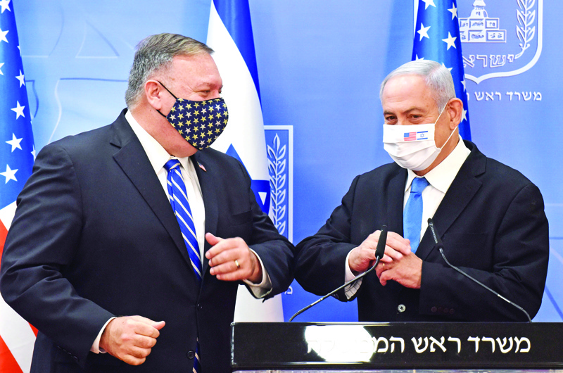 US Secretary of State Mike Pompeo (L) and Israeli Prime Minister Benjamin Netanyahu bump elbows ahead of making a joint statement to the press after meeting in Jerusalem, on August 24, 2020. - Pompeo arrived in Israel kicking off a five-day visit to the Middle East which will take him to Sudan, the United Arab Emirates, and Bahrain, focusing on Israel's normalising of ties with the UAE and pushing other Arab states to follow suit. (Photo by DEBBIE HILL / POOL / AFP)