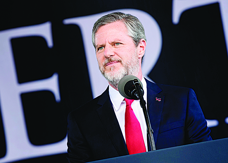 (FILES) In this file photo taken on May 13, 2017, President of Liberty University, Jerry Falwell, Jr., speaks  during Liberty University's commencement ceremony in Lynchburg, Virginia. - Falwell, a vocal supporter of US President Donald Trump, has taken an indefinite leave of absence as president of the evangelical university amid a furor over an Instagram picture of him and a young woman, both with pants partly unzipped. He himself had posted the controversial picture showing him standing on a private yacht with one hand around the waist of a young woman -- later said to be his wife's assistant -- and the other holding an unidentified dark beverage. Both sport broad smiles and have their zippers a few inches down, baring their midriffs. (Photo by Brendan Smialowski / AFP)