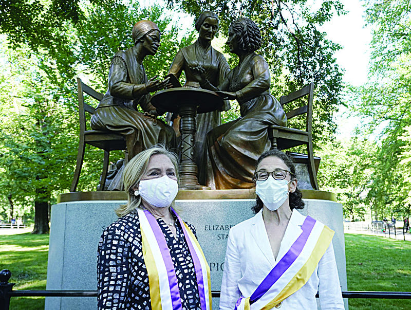 Former US Secretary of State and former presidential candidate Hillary Clinton poses with sculptor Meredith Bergmann after the unveiling of the statue of women's rights pioneers Susan B. Anthony, Elizabeth Cady Stanton and Sojourner Truth in Central Park in New York on August 26, 2020, marking the park's first statue of real-life women. (Photo by TIMOTHY A. CLARY / AFP) / RESTRICTED TO EDITORIAL USE - MANDATORY MENTION OF THE ARTIST UPON PUBLICATION - TO ILLUSTRATE THE EVENT AS SPECIFIED IN THE CAPTION