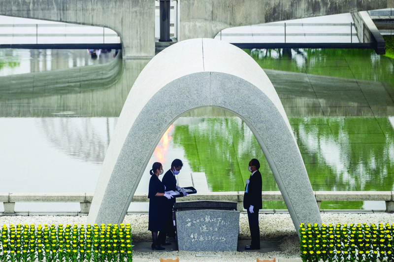 Hiroshima mayor Kazumi Matsui (R) and representatives of bereaved families take part in a ceremony at the Memorial Cenotaph during the 75th anniversary memorial service for atomic bomb victims at the Peace Memorial Park in Hiroshima on August 6, 2020. - Japan on August 6, 2020 marked 75 years since the world's first atomic bomb attack, with the COVID-19 coronavirus pandemic forcing a scaling back of annual ceremonies to commemorate the victims. (Photo by Philip FONG / AFP)