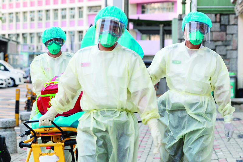 Medical staff wearing personal protective equipment (PPE) as a precautionary measure against the COVID-19 coronavirus approach Lei Muk Shue care home in Hong Kong on August 23, 2020. (Photo by May JAMES / May James / AFP)
