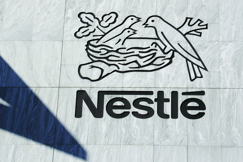 (FILES) In this file photo taken on August 23, 2006 the logo of Nestle, the Swiss food giant, is seen on the company's Headquarters in Vevey. - Swiss food giant Nestle acquired American allergy specialist Aimmune Therapeutics it was announced on August 31, 2020. (Photo by Fabrice COFFRINI / AFP)