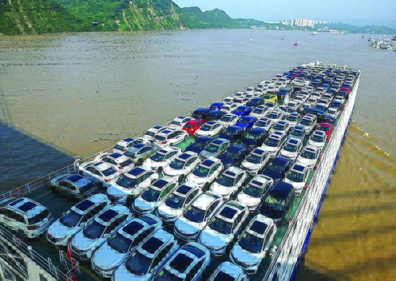 This photo taken on August 2, 2020 shows a cargo ship carrying cars making its way on the Yangtze River in Yichang in China's central Hubei province. (Photo by STR / AFP) / China OUT