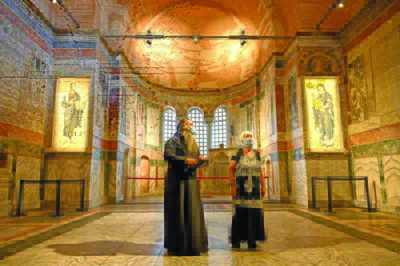 A priest (L) and a woman visit the Chora or Kariye Museum, formally the Church of the Holy Saviour, a medieval Byzantine Greek Orthodox church,  on August 21, 2020, in the Fatih district in Istanbul. - Turkish President Recep Tayyip Erdogan on August 21, 2020, ordered another ancient Orthodox church that became a mosque and then a popular Istanbul museum to be turned back into a place of Muslim worship. Located in today's Fatih district in Istanbul, the building was constructed as a monastery in 534 during the Byzantine period. After Istanbul was taken over by the Ottomans in 1453, it was converted into a mosque in 1511, just like Hagia Sophia in Istanbul. Serving as a mosque for 434 years, it was converted into a museum by a Council of Ministers decree in 1945, after the Republic of Turkey was established in 1923. (Photo by BULENT KILIC / AFP)
