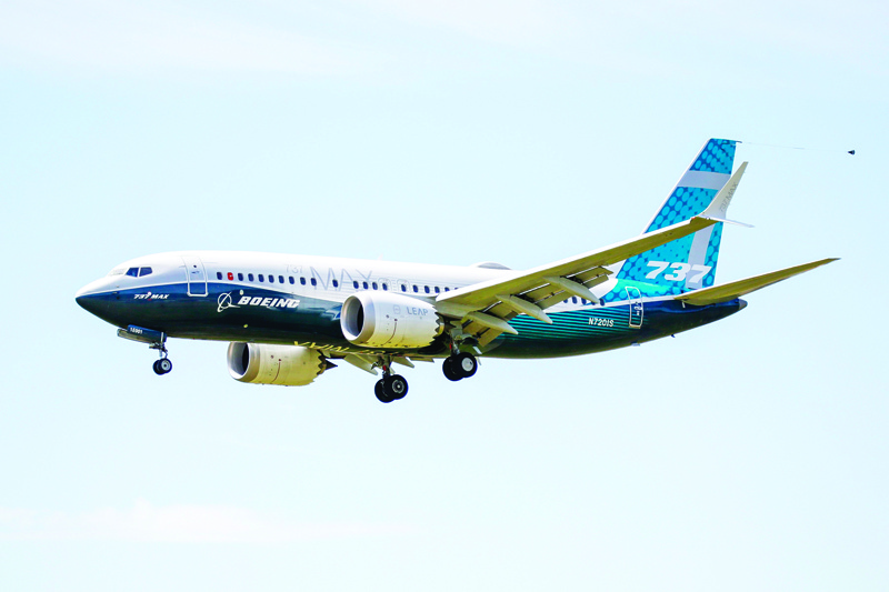 (FILES) In this file photo taken on June 29, 2020 a Boeing 737 MAX jet comes in for a landing following a Federal Aviation Administration (FAA) test flight at Boeing Field in Seattle, Washington. - Boeing reported a bigger-than-expected loss on July 29, 2020 and said it would further trim its plane production because of weak demand in the wake of the coronavirus. The aerospace giant suffered a $2.4 billion second-quarter loss, reflecting the hit from much lower commercial plane deliveries as airlines suspend purchases due to falling consumer demand. (Photo by Jason Redmond / AFP)