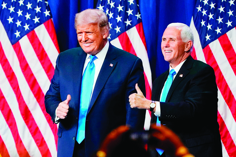 US President Donald Trump and Vice President Mike Pence give a thumbs up after speaking during the first day of the Republican National Convention on August 24, 2020, in Charlotte, North Carolina. - President Donald Trump went into battle for a second term Monday with his nomination at a Republican convention where he will draw on all his showman's instincts to try and change the narrative in an election he is currently set to lose. (Photo by Chris Carlson / POOL / AFP)