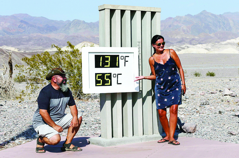 DEATH VALLEY NATIONAL PARK, CALIFORNIA - AUGUST 17: Visitors gather for a photo in front of an unofficial thermometer at Furnace Creek Visitor Center on August 17, 2020 in Death Valley National Park, California. The temperature reached 130 degrees at Death Valley National Park on August 16, hitting what may be the hottest temperature recorded on Earth since at least 1913, according to the National Weather Service. Park visitors have been warned, Travel prepared to survive.   Mario Tama/Getty Images/AFPn== FOR NEWSPAPERS, INTERNET, TELCOS &amp; TELEVISION USE ONLY ==