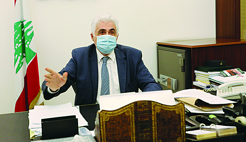 Lebanon's Foreign Minister Nassif Hitti is pictured wearing a face mask due to the coronavirus in his office in the capital Beirut, on August 3, 2020. - Hitti announced his resignation today due to the government's mishandling of the country's worst crisis in decades, as premier Hasan Diab's under-fire cabinet struggles to secure international support. (Photo by ANWAR AMRO / AFP)