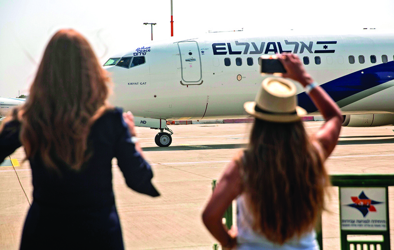 TOPSHOT - A picture taken on August 31, 2020, shows Israeli women taking pictures of the El Al's airliner, ahead of the first-ever commercial flight from Israel to the UAE at the Ben Gurion Airport near Tel Aviv, which will carry a US-Israeli delegation to the UAE following a normalisation accord. (Photo by Heidi levine / POOL / AFP)