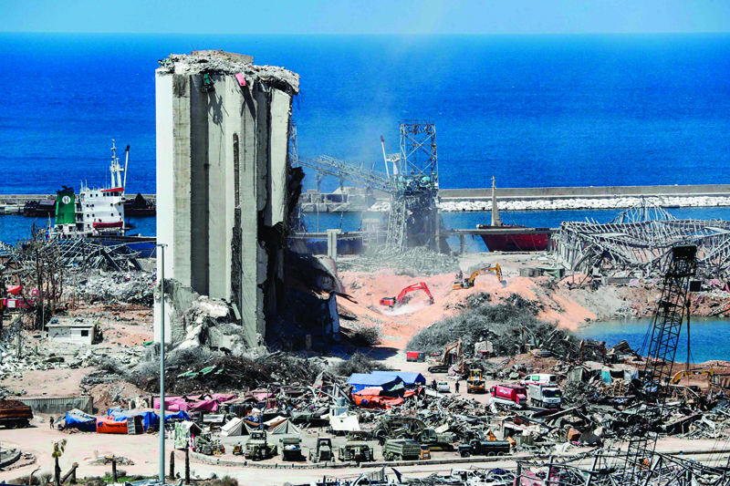 TOPSHOT - Diggers remove earth at the blast site next to the silos at the port of Beirut on August 16, 2020, in the aftermath of the massive explosion there that ravaged Lebanon's capital. (Photo by ANWAR AMRO / AFP)