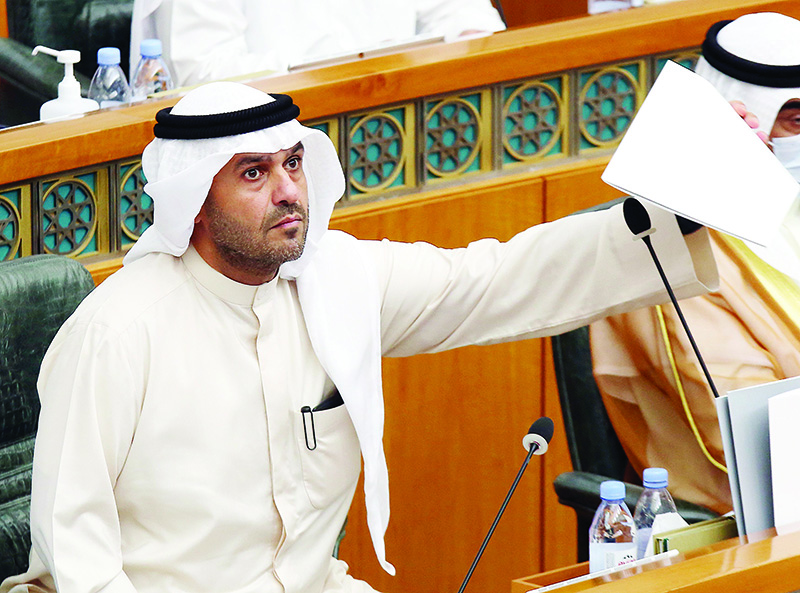Kuwaiti Interior Minister Anas al-Saleh holds a document during a parliamentary session at the national assembly in Kuwait City on August 26, 2020. - Kuwait's national assembly rejected a no-confidence motion against Saleh with 35 members supporting him. He was opposed by 13 members. (Photo by YASSER AL-ZAYYAT / AFP)