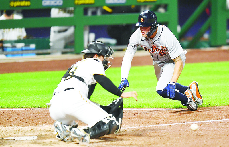 PITTSBURGH:  JaCoby Jones #21 of the Detroit Tigers scores in front of John Ryan Murphy #18 of the Pittsburgh Pirates during the tenth inning at PNC Park on August 7, 2020 in Pittsburgh, Pennsylvania. —AFP