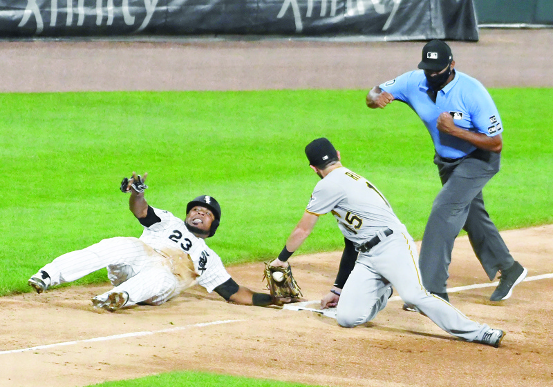CHICAGO, ILLINOIS - AUGUST 25: Edwin Encarnacion #23 of the Chicago White Sox is tagged out at third base by JT Riddle #15 of the Pittsburgh Pirates during the third inning at Guaranteed Rate Field on August 25, 2020 in Chicago, Illinois.   David Banks/Getty Images/AFP
