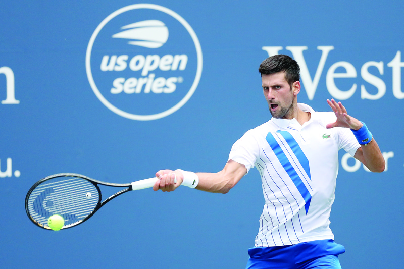 NEW YORK, NEW YORK - AUGUST 28: Novak Djokovic of Serbia returns a shot to Roberto Bautista Agut of Spain in their semifinal match during the Western &amp; Southern Open at the USTA Billie Jean King National Tennis Center on August 28, 2020 in the Queens borough of New York City.   Matthew Stockman/Getty Images/AFP