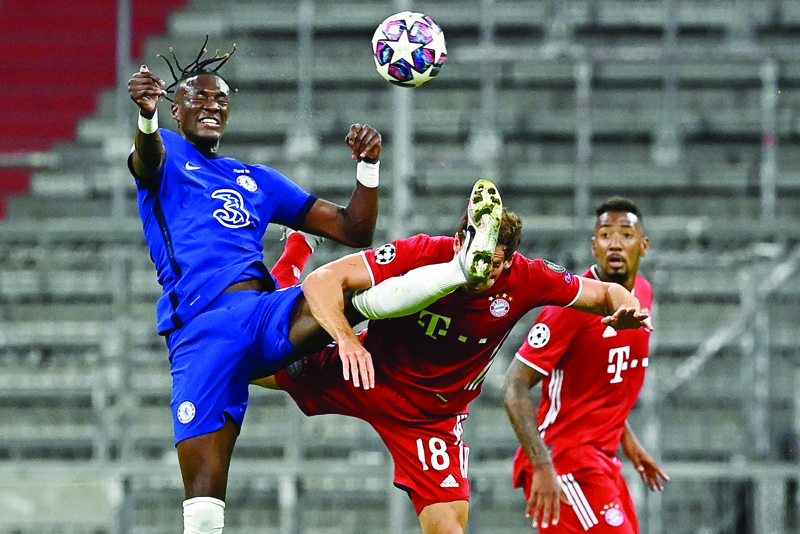 Chelsea's English striker Tammy Abraham (L) fights for the ball with Bayern Munich's German midfielder Leon Goretzka during the UEFA Champions League, second-leg round of 16, football match FC Bayern Munich v FC Chelsea in Munich, southern Germany on August 8, 2020. (Photo by Tobias SCHWARZ / AFP)