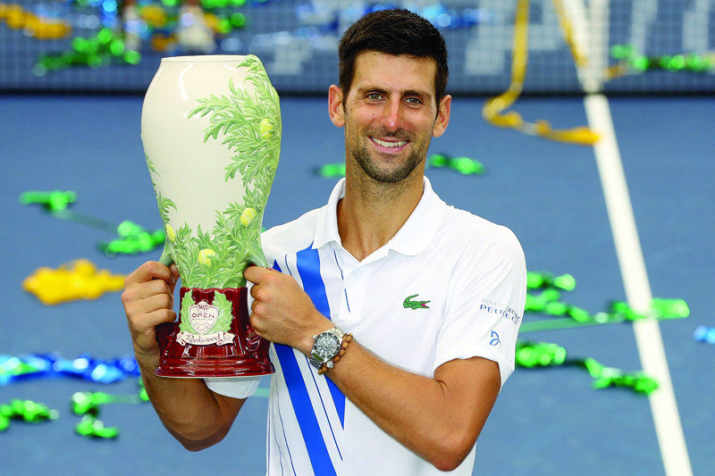 NEW YORK, NEW YORK - AUGUST 29: Novak Djokovic of Serbia poses with the winner's trophy after defeating Milos Raonic of Canada in the men's singles final of the Western &amp; Southern Open at the USTA Billie Jean King National Tennis Center on August 29, 2020 in the Queens borough of New York City.   Matthew Stockman/Getty Images/AFPn== FOR NEWSPAPERS, INTERNET, TELCOS &amp; TELEVISION USE ONLY ==
