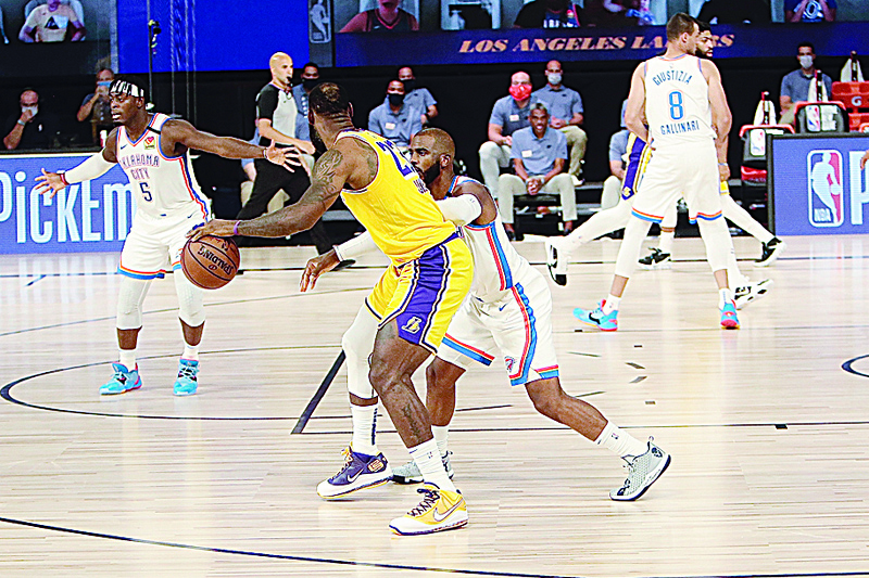 ORLANDO, FL - AUGUST 5: Chris Paul #3 of the Oklahoma City Thunder defends against LeBron James #23 of the Los Angeles Lakers as part of the NBA Restart 2020 on August 5, 2020 at HP Field House at ESPN Wide World of Sports Complex in Orlando, Florida. NOTE TO USER: User expressly acknowledges and agrees that, by downloading and/or using this photograph, user is consenting to the terms and conditions of the Getty Images License Agreement. Mandatory Copyright Notice: Copyright 2020 NBAE   Jim Poorten/NBAE via Getty Images/AFP