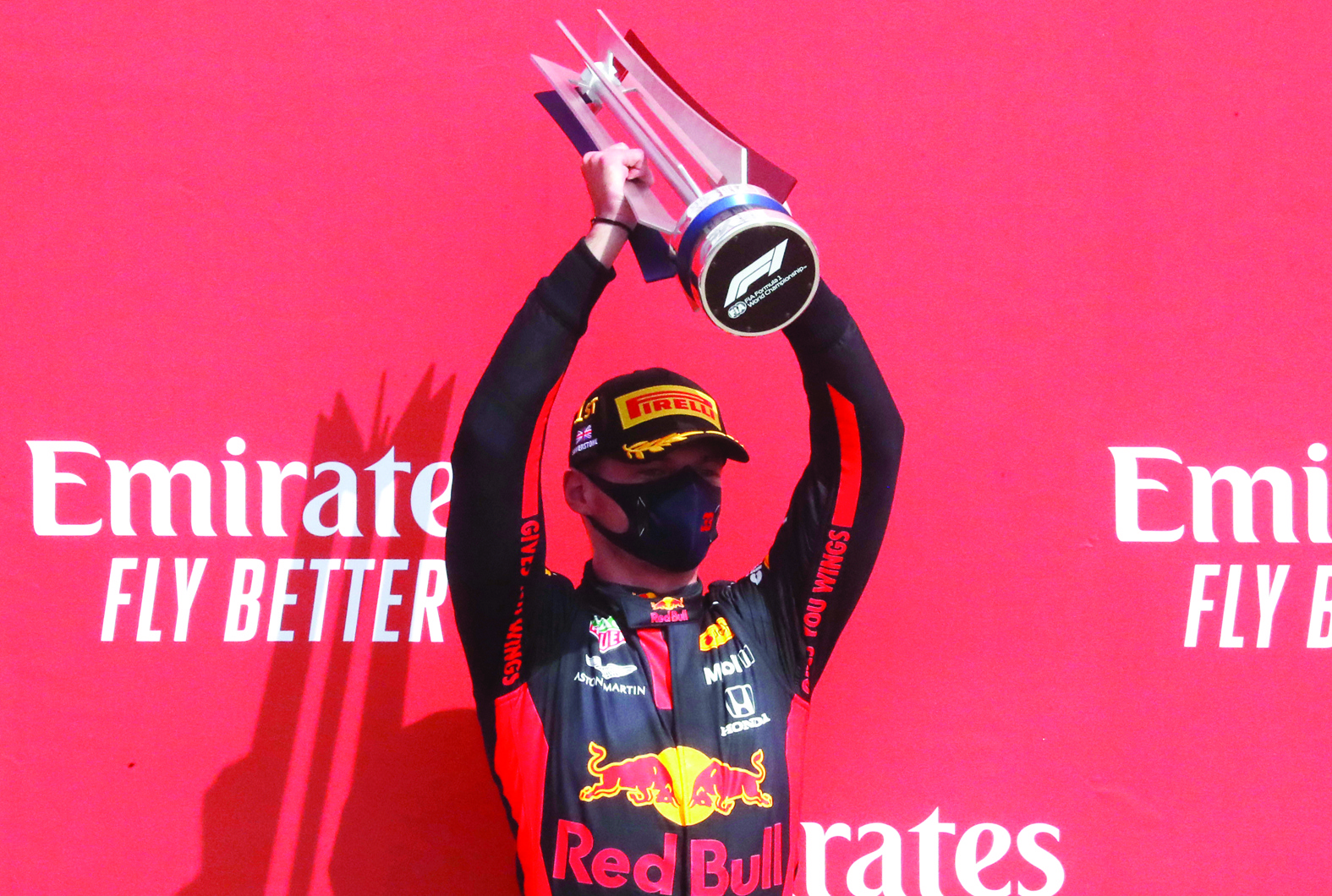 Winner Red Bull's Dutch driver Max Verstappen holds up the trophy on the podium during the presentation for the F1 70th Anniversary Grand Prix at Silverstone on August 9, 2020 in Northampton. - The race commemorates the 70th anniversary of the inaugural world championship race, held at Silverstone in 1950. (Photo by Frank Augstein / POOL / AFP)