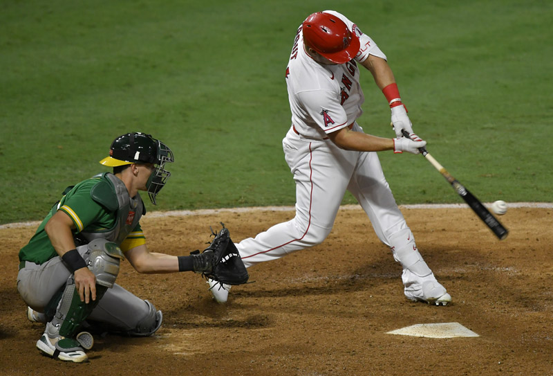 ANAHEIM, CA - AUGUST 10: Sean Murphy #12 of the Oakland Athletics looks on as Mike Trout #27 of the Los Angeles Angels hits a home run against the Oakland Athletics in the eighth inning at Angel Stadium of Anaheim on August 10, 2020 in Anaheim, California.   John McCoy/Getty Images/AFP