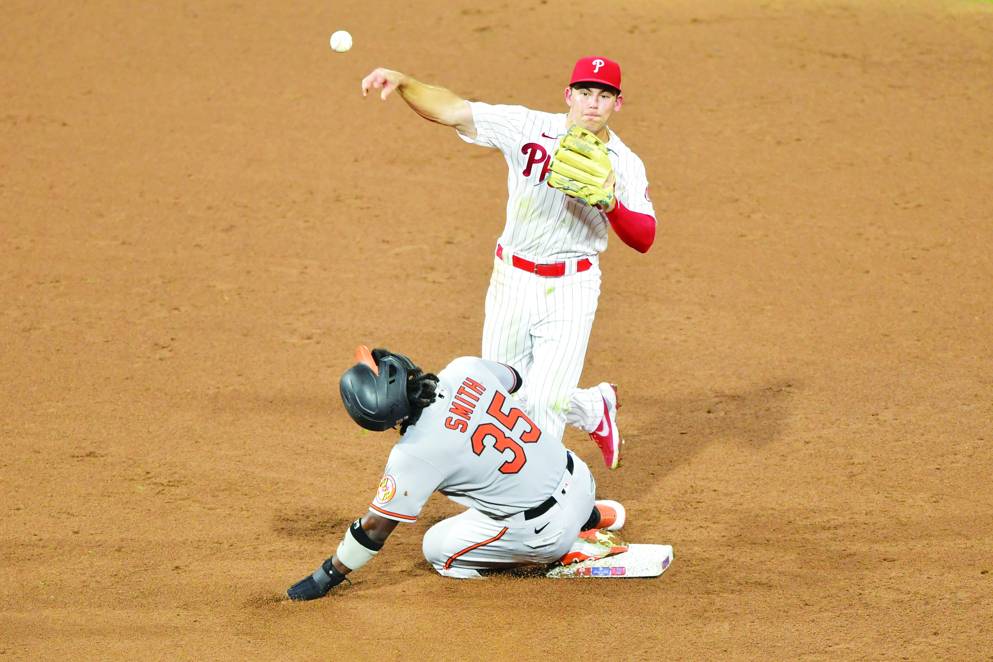 PHILADELPHIA, PA - AUGUST 11: Scott Kingery #4 of the Philadelphia Phillies forces out Dwight Smith Jr. #35 of the Baltimore Orioles at second base on an attempted double play in the sixth inning at Citizens Bank Park on August 11, 2020 in Philadelphia, Pennsylvania.   Drew Hallowell/Getty Images/AFP