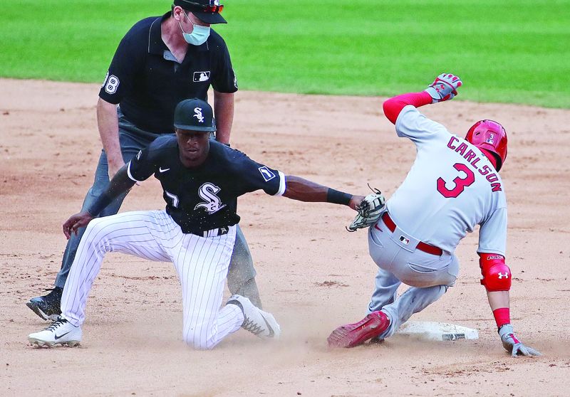 CHICAGO, ILLINOIS - AUGUST 15: Dylan Carlson #3 of the St. Louis Cardinals slides into second base with a double in the 5th inning ahead of the tag attempt by Tim Anderson #7 of the Chicago White Sox at Guaranteed Rate Field on August 15, 2020 in Chicago, Illinois.   Jonathan Daniel/Getty Images/AFPn== FOR NEWSPAPERS, INTERNET, TELCOS &amp; TELEVISION USE ONLY ==