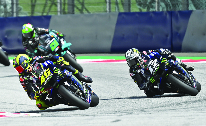 Monster Energy Yamaha's Italian rider Valentino Rossi (L) and Monster Energy Yamaha' Spanish rider Maverick Vinales compete during the Moto GP Austrian Grand Prix at the Red Bull Ring circuit in Spielberg, Austria on August 16, 2020. (Photo by Joe Klamar / AFP)