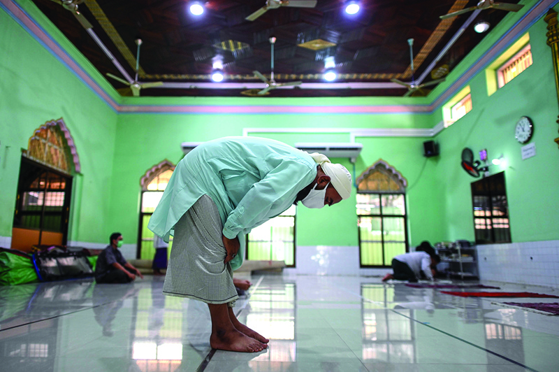 This photo taken on June 20, 2020 shows Muslims praying inside a mosque in Meiktila, Mandalay Region. - The majority-Buddhist nation is widely expected to return Aung San Suu Kyi's National League for Democracy (NLD) party to power on November 8 in the second polls since Myanmar emerged from outright military rule in 2011. The country's Rohingya Muslims -- whether in Bangladeshi refugee shelters or confined to camps and villages in Myanmar -- will nearly all be completely disenfranchised. (Photo by Ye Aung THU / AFP) / TO GO WITH AFP STORY Myanmar-vote-justice-rights-religion-Islam