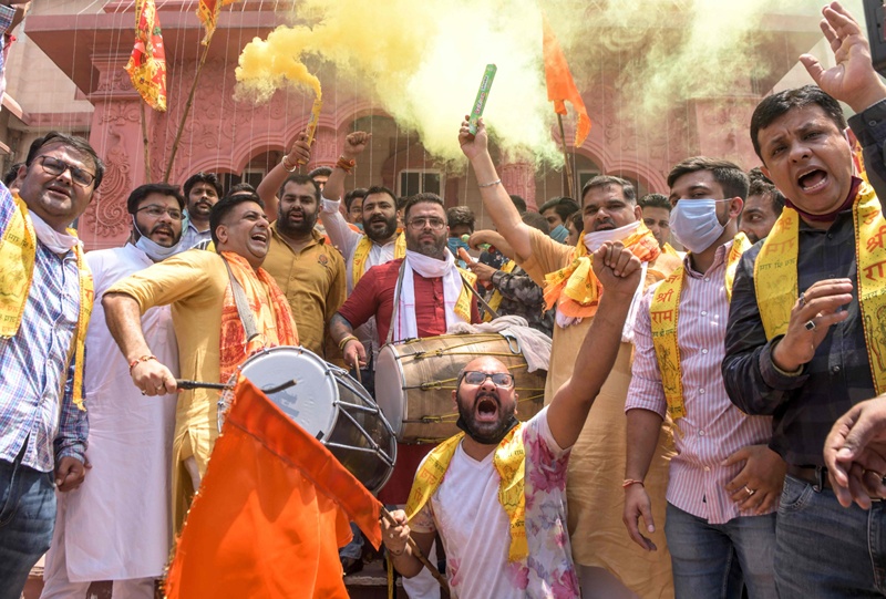 Workers of Bharatiya Janata Yuva Morcha, the youth wing of the Bharatiya Janata Party (BJP), burn crackers as they celebrate the groundbreaking ceremony of the Ram Temple in Ayodhaya, at the Ram Tirath Temple in Amritsar on August 5, 2020. - India's Prime Minister Narendra Modi will lay the foundation stone for a grand Hindu temple in a highly anticipated ceremony on August 5 at a holy site that was bitterly contested by Muslims, officials said. The Supreme Court ruled in November 2019 that a temple could be built in Ayodhya, where Hindu zealots demolished a 460-year-old mosque in 1992. (Photo by NARINDER NANU / AFP)