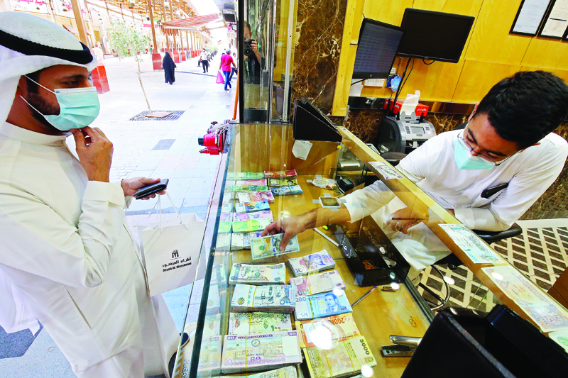 A Kuwaiti man stops at a currency exchange shop in Kuwait City on September 7, 2020, a sector heavily affected by the COVID-19 pandemic which caused a sharp drop in travel and tourism. (Photo by YASSER AL-ZAYYAT / AFP)