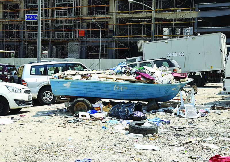 KUWAIT: An abandoned boat used as a makeshift garbage container and filled with construction material waste and other forms of trash near a construction site in Mahboula. - Photo by Fouad Al-Shaikh