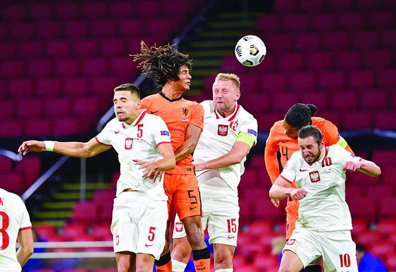 AMSTERDAM: Poland’s defender Jan Bednarek (L) vies with Dutch’s defender Nathan Ake (C) during the UEFA Nations League football match between Netherlands and Poland at the Johan Cruijff Arena stadium, in Amsterdam. — AFP
