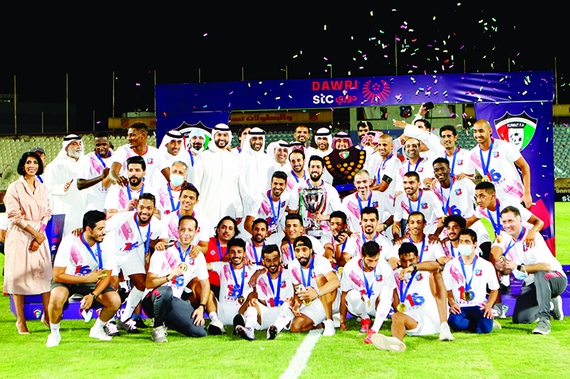 Jubilant Kuwait Sports Club players and officials with STC trophy.