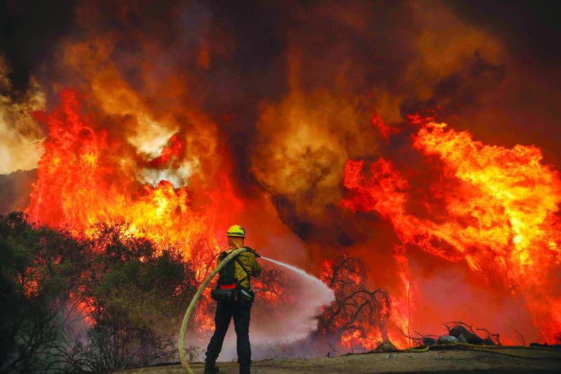 TOPSHOT - San Miguel County Firefighters battle a brush fire along Japatul Road during the Valley Fire in Jamul, California on September 6, 2020 - The Valley Fire in the Japatul Valley burned 4,000 acres overnight with no containment and 10 structures destroyed, Cal Fire San Diego said. (Photo by SANDY HUFFAKER / AFP)